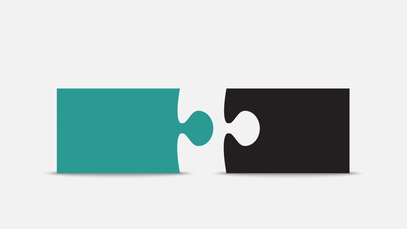 Two large puzzle pieces seperated, the left piece is teal and the right piece is black
